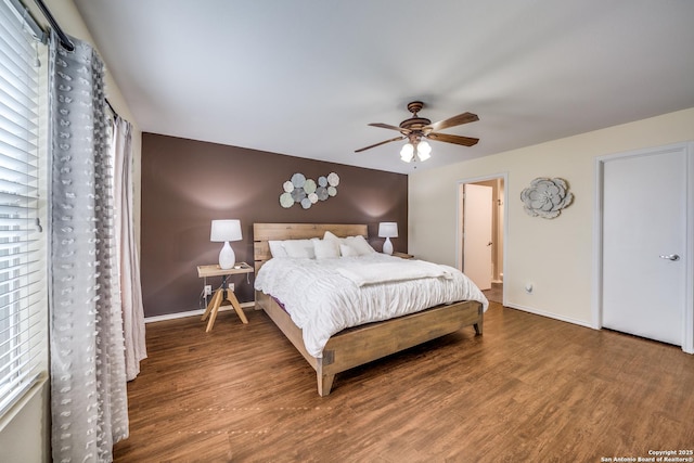 bedroom with baseboards, wood finished floors, and ceiling fan