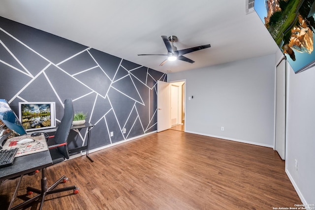 office space with wood finished floors, baseboards, ceiling fan, and visible vents