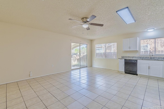 kitchen featuring light tile patterned flooring, a sink, a ceiling fan, white cabinetry, and black dishwasher
