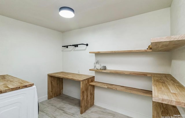 interior space featuring marble finish floor and baseboards