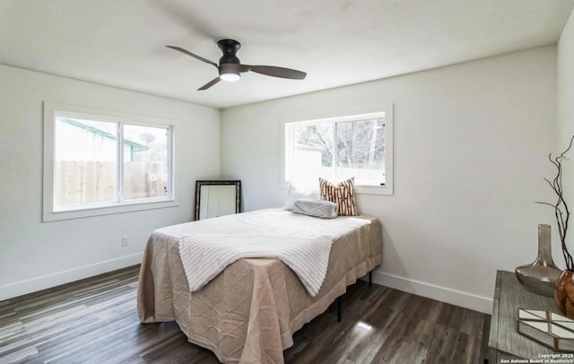 bedroom with dark wood finished floors, baseboards, and a ceiling fan
