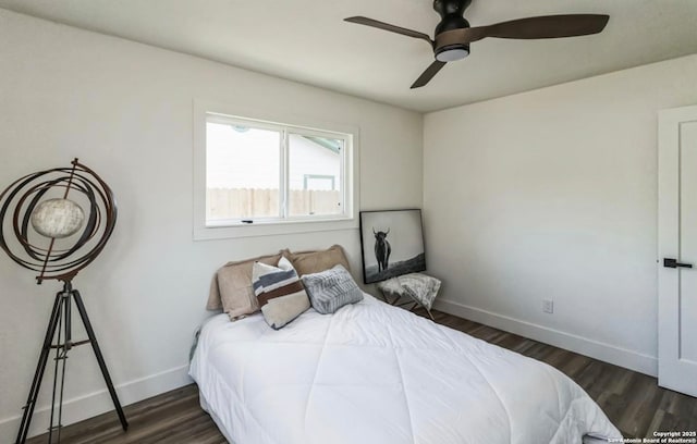 bedroom with baseboards, wood finished floors, and ceiling fan
