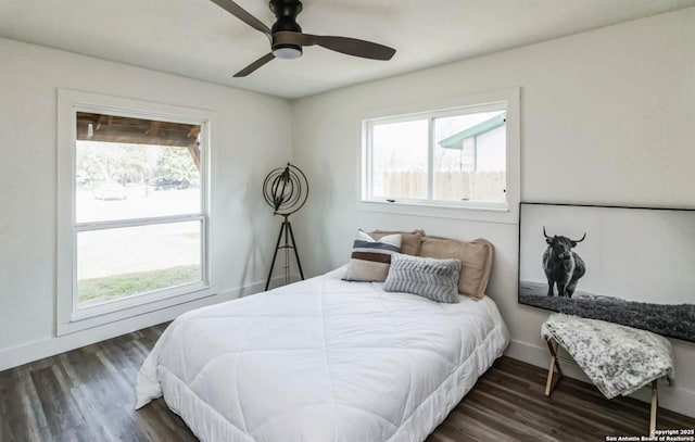 bedroom with baseboards, ceiling fan, and wood finished floors
