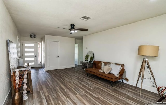 unfurnished room with baseboards, visible vents, wood finished floors, and ceiling fan