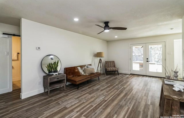 sitting room featuring baseboards, dark wood-style floors, french doors, and ceiling fan