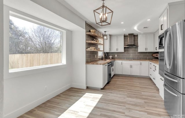 kitchen featuring tasteful backsplash, open shelves, stainless steel appliances, baseboards, and wall chimney exhaust hood