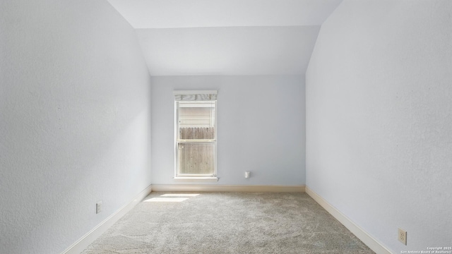 2144 Pioneer Pass, Seguin, TX 78155 - carpeted empty room with a textured wall, baseboards, and lofted ceiling