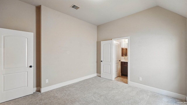 2144 Pioneer Pass, Seguin, TX 78155 - unfurnished bedroom featuring light colored carpet, vaulted ceiling, baseboards, and ensuite bathroom