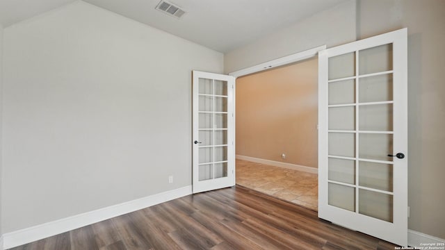 2144 Pioneer Pass, Seguin, TX 78155 - unfurnished room featuring french doors, dark wood-style floors, baseboards, and vaulted ceiling