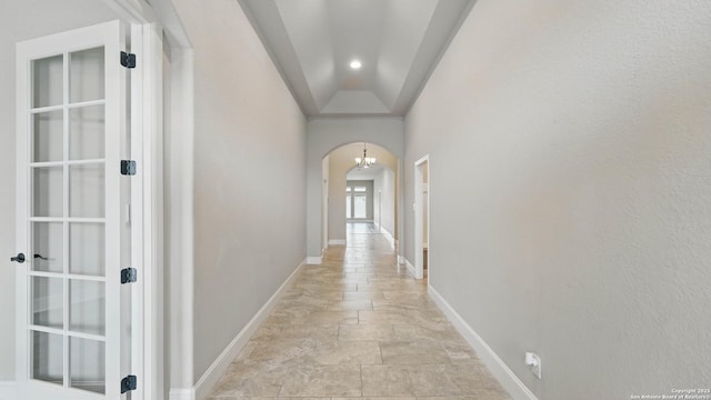 2144 Pioneer Pass, Seguin, TX 78155 - hall featuring arched walkways, light stone finish floors, and baseboards
