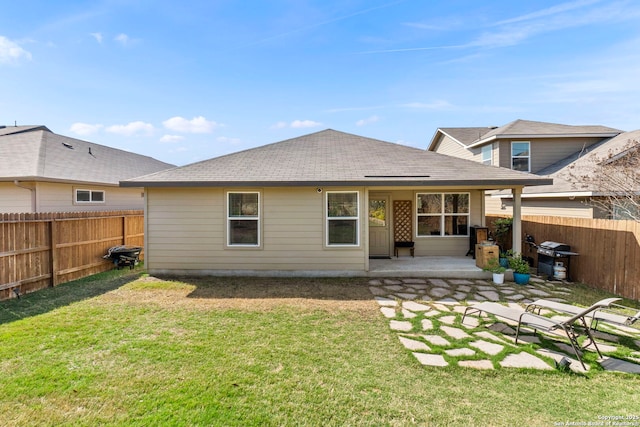 7015 Capella Cir, San Antonio, TX 78252 - rear view of house with a fenced backyard, roof with shingles, a yard, and a patio