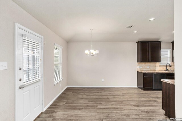 kitchen with tasteful backsplash, a notable chandelier, visible vents, dishwasher, and dark brown cabinets