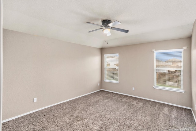 unfurnished room with baseboards, ceiling fan, carpet flooring, and a textured ceiling