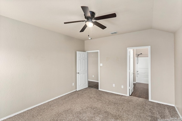 unfurnished bedroom featuring visible vents, carpet, baseboards, a ceiling fan, and vaulted ceiling