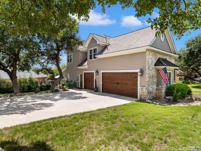 922 Split Fairway, San Antonio, TX 78260 - view of front of house with concrete driveway, stucco siding, roof with shingles, stone siding, and a front yard
