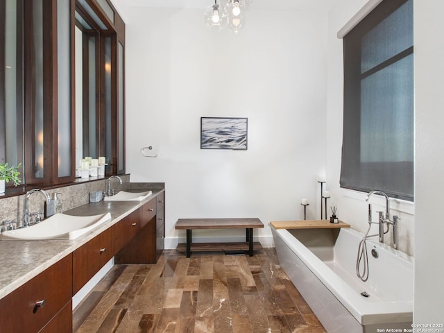 7110 Bella Rose, San Antonio, TX 78256 - bathroom with double vanity, a sink, a freestanding tub, and decorative backsplash