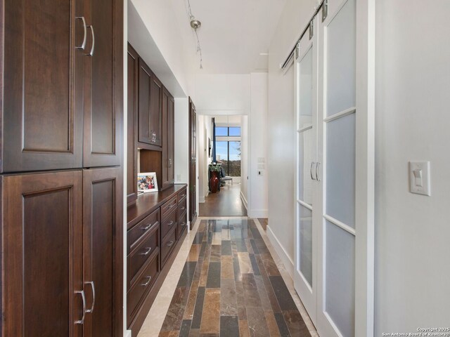 7110 Bella Rose, San Antonio, TX 78256 - hallway featuring rail lighting, stone finish floor, and baseboards
