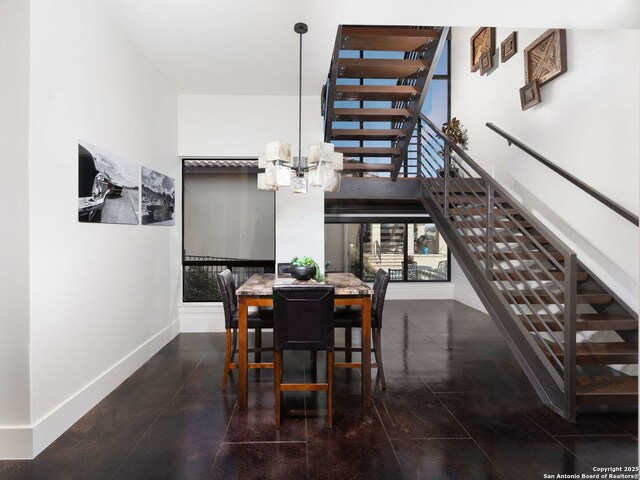 7110 Bella Rose, San Antonio, TX 78256 - dining space featuring baseboards, stairs, a towering ceiling, and an inviting chandelier