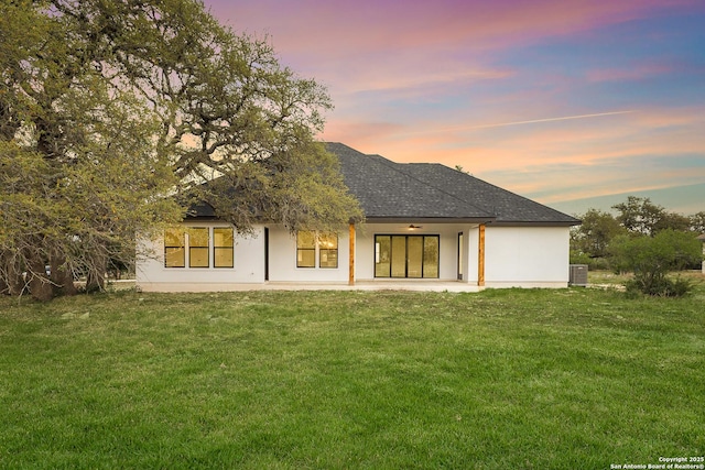 220 Toucan, Spring Branch, TX 78070 - back of house at dusk with a patio area, a yard, stucco siding, and cooling unit