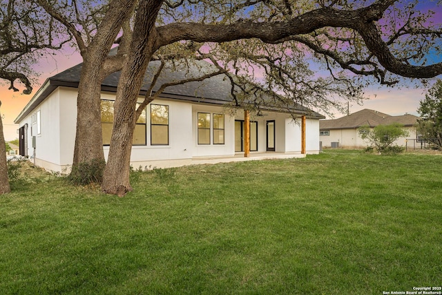 220 Toucan, Spring Branch, TX 78070 - back of house featuring stucco siding, a yard, a shingled roof, and a patio area