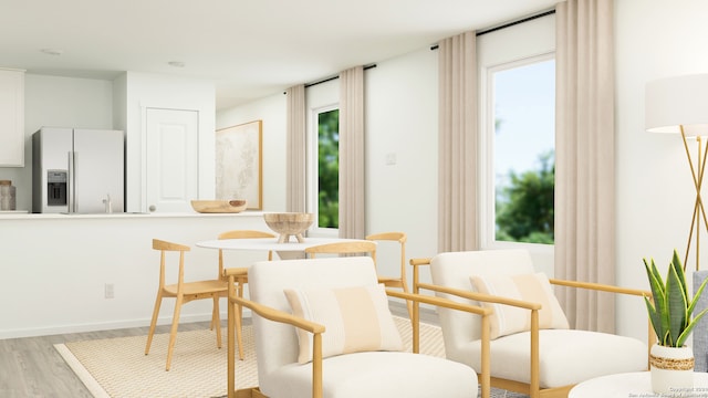 dining area featuring baseboards and light wood-type flooring