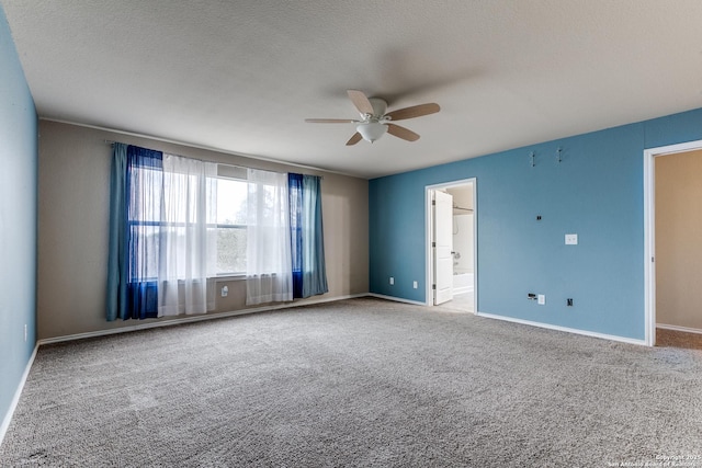 spare room with carpet flooring, a ceiling fan, baseboards, and a textured ceiling