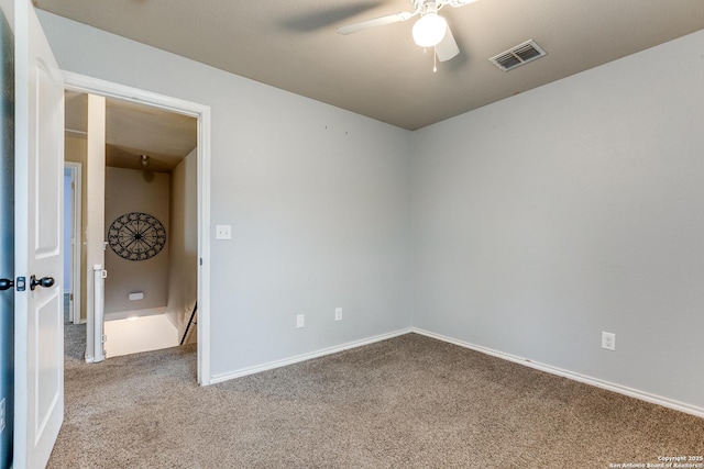 unfurnished room featuring baseboards, visible vents, ceiling fan, and carpet floors