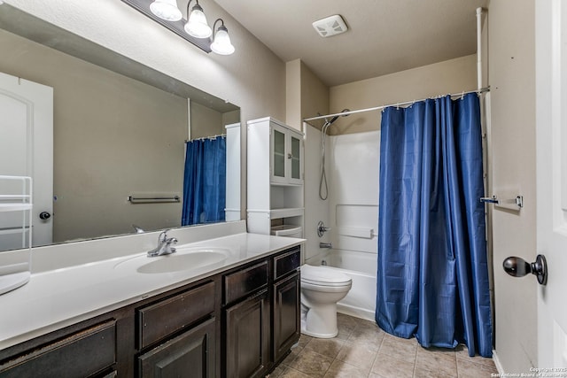 full bathroom featuring tile patterned floors, toilet, vanity, shower / bath combo with shower curtain, and visible vents