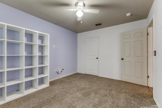 unfurnished bedroom with baseboards, carpet floors, ceiling fan, and visible vents