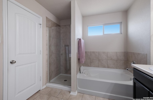 bathroom with a shower stall, tile patterned floors, a bath, and vanity