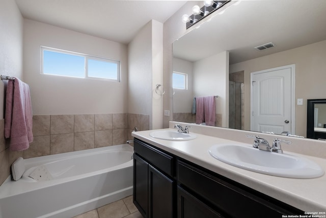 bathroom featuring visible vents, tile patterned flooring, a sink, and a bath