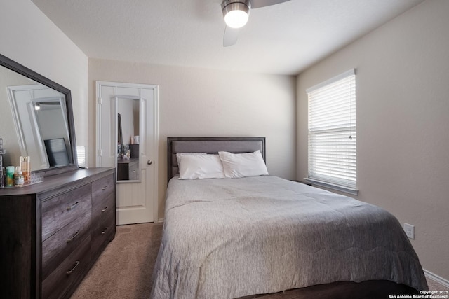 bedroom featuring a ceiling fan and dark carpet