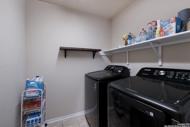 laundry room featuring independent washer and dryer, light tile patterned flooring, baseboards, and laundry area