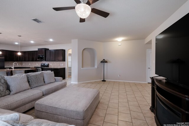 living room with recessed lighting, light tile patterned floors, baseboards, ceiling fan, and visible vents