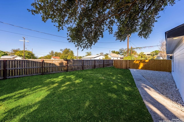 view of yard with a fenced backyard