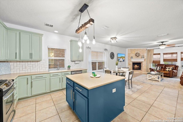 kitchen featuring light tile patterned flooring, visible vents, plenty of natural light, and appliances with stainless steel finishes