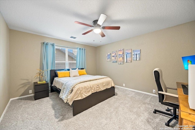 bedroom featuring baseboards, carpet flooring, a textured ceiling, and visible vents