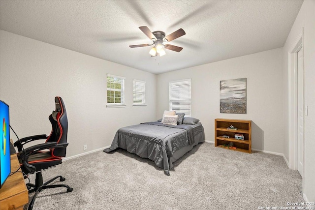 bedroom with baseboards, carpet floors, and a textured ceiling