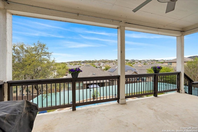 exterior space featuring grilling area, a balcony, a residential view, and ceiling fan