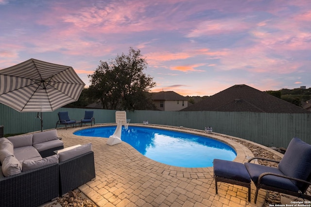 view of pool featuring a fenced backyard, a fenced in pool, an outdoor living space, and a patio