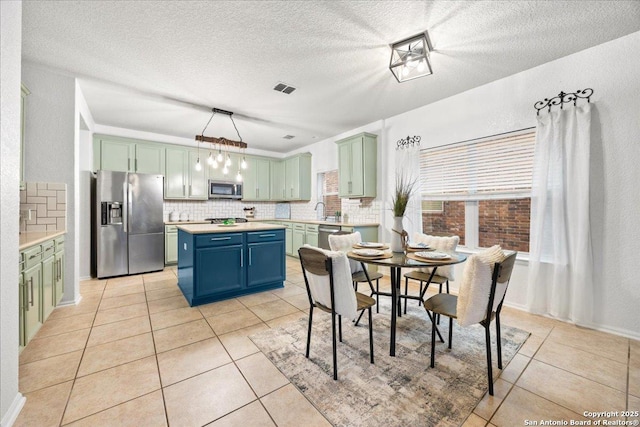 dining room with light tile patterned floors, a textured ceiling, and visible vents