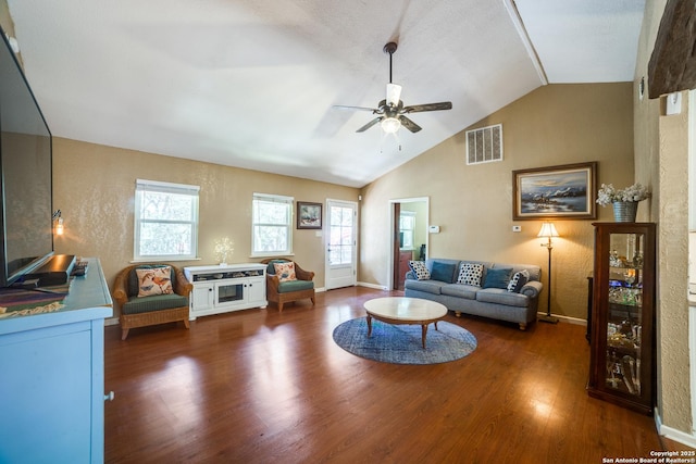 living room featuring vaulted ceiling, baseboards, ceiling fan, visible vents, and wood finished floors