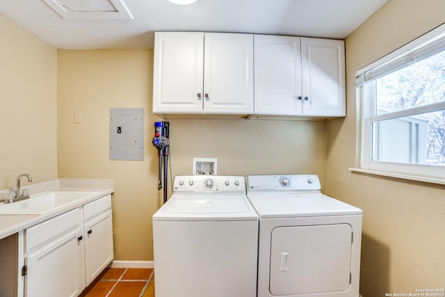 laundry room featuring tile patterned floors, a sink, cabinet space, washer and dryer, and electric panel