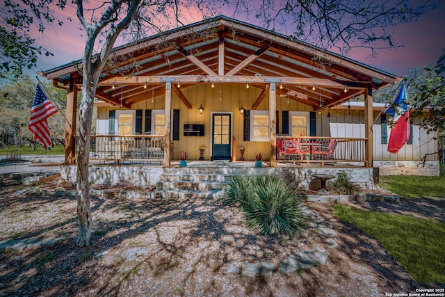 rustic home with board and batten siding and a porch