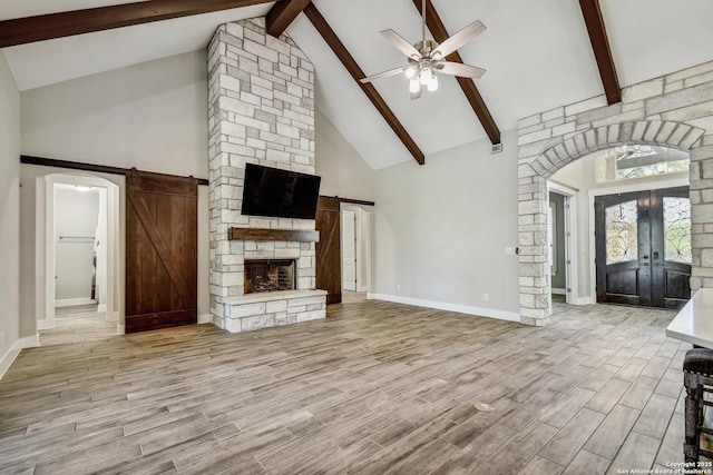 1609 Havenwood, New Braunfels, TX 78132 - unfurnished living room with french doors, a ceiling fan, beam ceiling, and wood finished floors