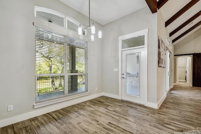 1609 Havenwood, New Braunfels, TX 78132 - foyer entrance with a notable chandelier, baseboards, beamed ceiling, and wood finished floors