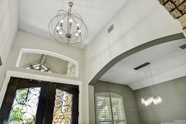 1609 Havenwood, New Braunfels, TX 78132 - foyer entrance with arched walkways, lofted ceiling, visible vents, and a chandelier