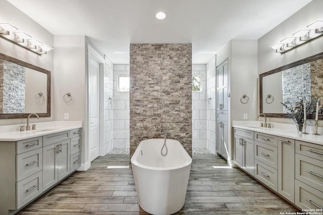 1609 Havenwood, New Braunfels, TX 78132 - bathroom featuring a sink, a freestanding tub, a walk in shower, and two vanities