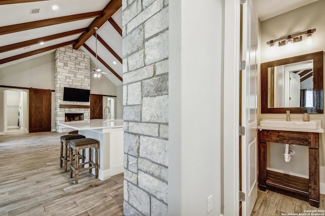 1609 Havenwood, New Braunfels, TX 78132 - interior space featuring a ceiling fan, high vaulted ceiling, beam ceiling, and light wood-type flooring