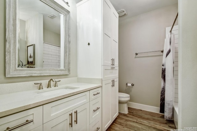 1609 Havenwood, New Braunfels, TX 78132 - bathroom with vanity, toilet, baseboards, curtained shower, and wood finished floors